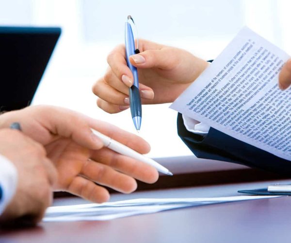 Business professionals reviewing service level agreement documents.